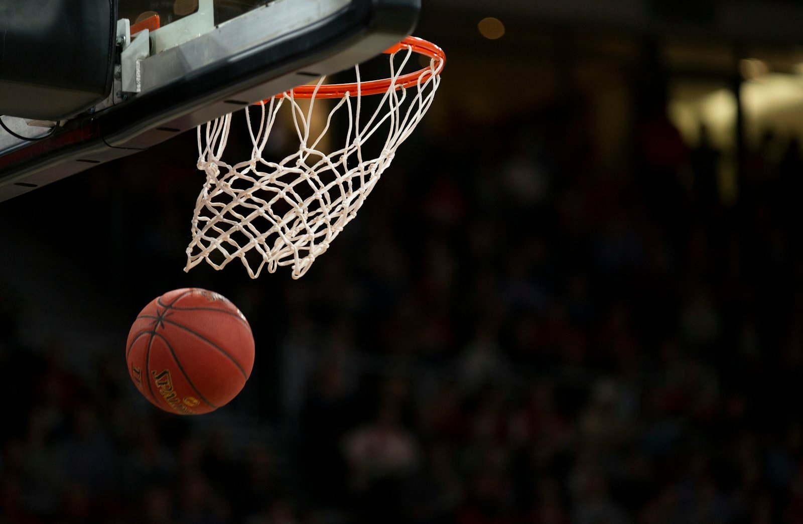 Basketball under arena lights representing renewed discussion around former NBA players