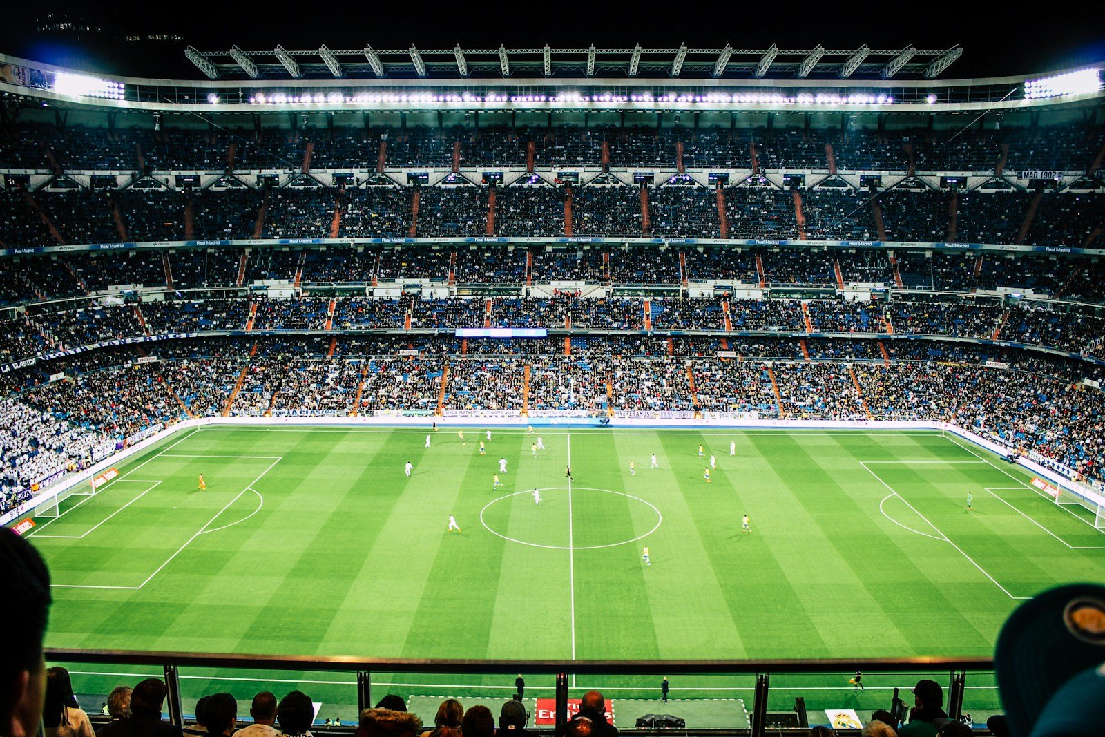 Soccer players compete under stadium lights